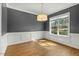 Charming dining room featuring hardwood floors, wainscoting and an elegant light fixture at 3659 Brooks Bnd, Franklinton, NC 27525