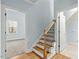 Inviting hallway with wooden stairs and natural light from a nearby window at 3659 Brooks Bnd, Franklinton, NC 27525