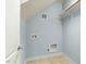 Bright laundry room featuring blue walls, tile flooring, and utility connections at 3659 Brooks Bnd, Franklinton, NC 27525