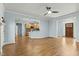 Open-concept living space with hardwood floors seamlessly connecting the living room and kitchen at 3659 Brooks Bnd, Franklinton, NC 27525