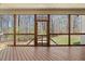 Covered porch with wood flooring, railing and serene backyard view at 3659 Brooks Bnd, Franklinton, NC 27525
