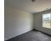 Bedroom with neutral carpet flooring and a bright window with natural light at 394 Springtooth Dr, Zebulon, NC 27597