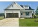 Charming single-story home featuring a two-car garage and well-maintained front lawn at 394 Springtooth Dr, Zebulon, NC 27597