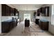 Bright kitchen with dark wood cabinets, stainless steel appliances, and a center island at 394 Springtooth Dr, Zebulon, NC 27597