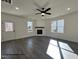 Living room featuring a fireplace, fan and windows with a wood mantle at 394 Springtooth Dr, Zebulon, NC 27597