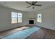 Cozy living room featuring a fireplace with a wooden mantle and lots of natural light at 394 Springtooth Dr, Zebulon, NC 27597