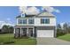 Inviting two-story home with gray brick, white siding and a two-car garage at 40 Granite Falls Way, Youngsville, NC 27596