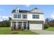 Inviting two-story home with gray brick, white siding and a two-car garage at 40 Granite Falls Way, Youngsville, NC 27596