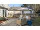 Outdoor patio with comfortable wicker furniture and umbrella for relaxation at 402 Homestead Park Dr, Apex, NC 27502