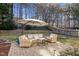 Outdoor patio with comfortable wicker furniture and umbrella for relaxation at 402 Homestead Park Dr, Apex, NC 27502