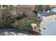 An aerial view of a well-maintained backyard with a patio and lawn at 402 Homestead Park Dr, Apex, NC 27502