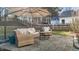 Outdoor patio with comfortable wicker furniture and umbrella for relaxation at 402 Homestead Park Dr, Apex, NC 27502