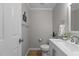 Half bathroom with white vanity, white toilet, and natural light at 402 Homestead Park Dr, Apex, NC 27502
