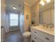 A well-lit bathroom with modern fixtures and a tub with shower at 402 Homestead Park Dr, Apex, NC 27502