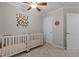 A charming Bedroom with two white cribs and a ceiling fan at 402 Homestead Park Dr, Apex, NC 27502