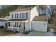 Charming two-story home boasts a welcoming front porch, attached garage, and well-maintained landscaping at 402 Homestead Park Dr, Apex, NC 27502