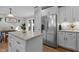 Kitchen island with stainless steel appliances and sliding door access to dining area at 402 Homestead Park Dr, Apex, NC 27502
