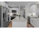 Kitchen island with stainless steel appliances and a view into a utility room at 402 Homestead Park Dr, Apex, NC 27502
