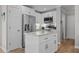 Kitchen featuring stainless steel appliances, white cabinets, granite countertops and an island at 402 Homestead Park Dr, Apex, NC 27502