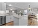Kitchen island with granite countertops and views of living and dining rooms at 402 Homestead Park Dr, Apex, NC 27502