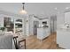 An open concept kitchen featuring stainless steel appliances, an island and sliding door access to the patio at 402 Homestead Park Dr, Apex, NC 27502