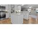 Kitchen island with stainless steel appliances and a view into the living room at 402 Homestead Park Dr, Apex, NC 27502