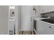 Laundry room with white washer and dryer, white cabinets, and a view to a bathroom at 402 Homestead Park Dr, Apex, NC 27502