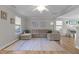 Bright living room boasts hardwood floors, a ceiling fan, and large windows that bring in lots of light at 402 Homestead Park Dr, Apex, NC 27502