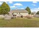 Backyard with a deck, fire pit, and well-manicured lawn for outdoor entertaining at 408 E Maple Ave, Holly Springs, NC 27540