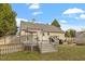 Charming backyard featuring a wooden deck and well-maintained lawn at 408 E Maple Ave, Holly Springs, NC 27540