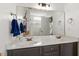 Double vanity with a large mirror offering ample space and lighting for a functional bathroom at 408 E Maple Ave, Holly Springs, NC 27540