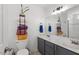 Bathroom with double vanity, storage for towels, and modern fixtures for convenience at 408 E Maple Ave, Holly Springs, NC 27540