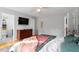 Bright bedroom featuring soft bedding and a wooden dresser, creating a relaxing atmosphere at 408 E Maple Ave, Holly Springs, NC 27540