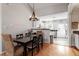 Cozy dining area features modern chandelier and hardwood floors at 408 E Maple Ave, Holly Springs, NC 27540
