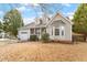 Charming two-story home with well-maintained lawn, attached garage, inviting front porch, and a lovely, landscaped front yard at 408 E Maple Ave, Holly Springs, NC 27540