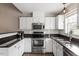 Updated kitchen with stainless steel appliances and granite countertops at 408 E Maple Ave, Holly Springs, NC 27540