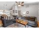 Open-concept living room featuring comfortable seating, a cozy fireplace, and seamless access to the adjacent kitchen and dining areas at 408 E Maple Ave, Holly Springs, NC 27540