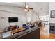 Open-concept living room featuring comfortable seating, a cozy fireplace, and seamless access to the adjacent kitchen and dining areas at 408 E Maple Ave, Holly Springs, NC 27540