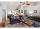 Open-concept living room featuring comfortable seating, a cozy fireplace, and seamless access to the adjacent kitchen and dining areas at 408 E Maple Ave, Holly Springs, NC 27540