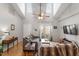 Bright living room with vaulted ceilings, hardwood floors, comfortable seating, and a sliding glass door to the backyard at 408 E Maple Ave, Holly Springs, NC 27540