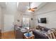 Bright living room with vaulted ceilings, hardwood floors, comfortable seating, and a sliding glass door to the backyard at 408 E Maple Ave, Holly Springs, NC 27540