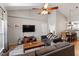 Open living room with vaulted ceilings, ceiling fan, and modern furnishings at 408 E Maple Ave, Holly Springs, NC 27540