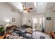 Bright living room with vaulted ceilings, hardwood floors, comfortable seating, and a sliding glass door to the backyard at 408 E Maple Ave, Holly Springs, NC 27540