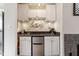 A cozy wet bar area with stainless steel mini-fridge, bar sign and a sink at 408 E Maple Ave, Holly Springs, NC 27540