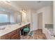 Bathroom with double sink vanity, large mirror, a bathtub, and a separate tub at 410 Pintail Ct, Durham, NC 27704