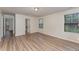 Spacious bedroom featuring wood-look floors and two bright windows with backyard views at 410 Pintail Ct, Durham, NC 27704