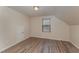 Bedroom featuring wood-look floors and a window with blinds at 410 Pintail Ct, Durham, NC 27704