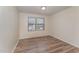 Cozy bedroom with wood-look flooring and natural light streaming in from the windows at 410 Pintail Ct, Durham, NC 27704