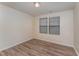 Bright bedroom with wood-look floors and a window at 410 Pintail Ct, Durham, NC 27704