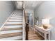 Bright entryway featuring stairs, wood floors, decorative table, and access to other rooms at 410 Pintail Ct, Durham, NC 27704